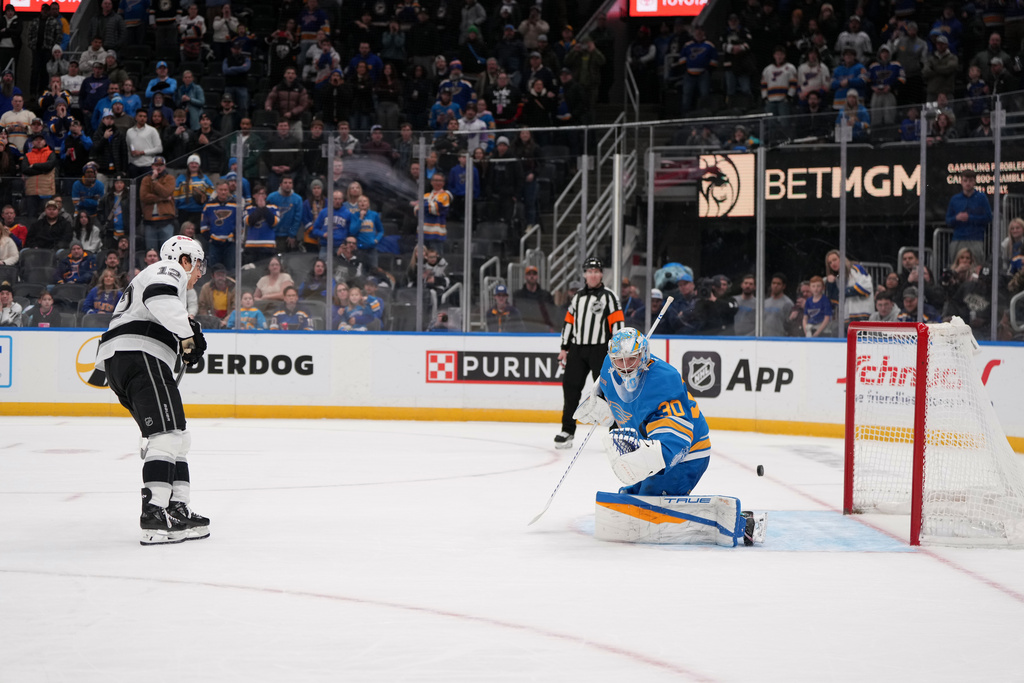 Los Angeles Kings' Trevor Moore (12) scores past St. Louis Blues goaltender Joel Hofer during a shootout of an NHL hockey game Saturday, Jan. 24, 2026, in St. Louis. (AP Photo/Jeff Roberson)