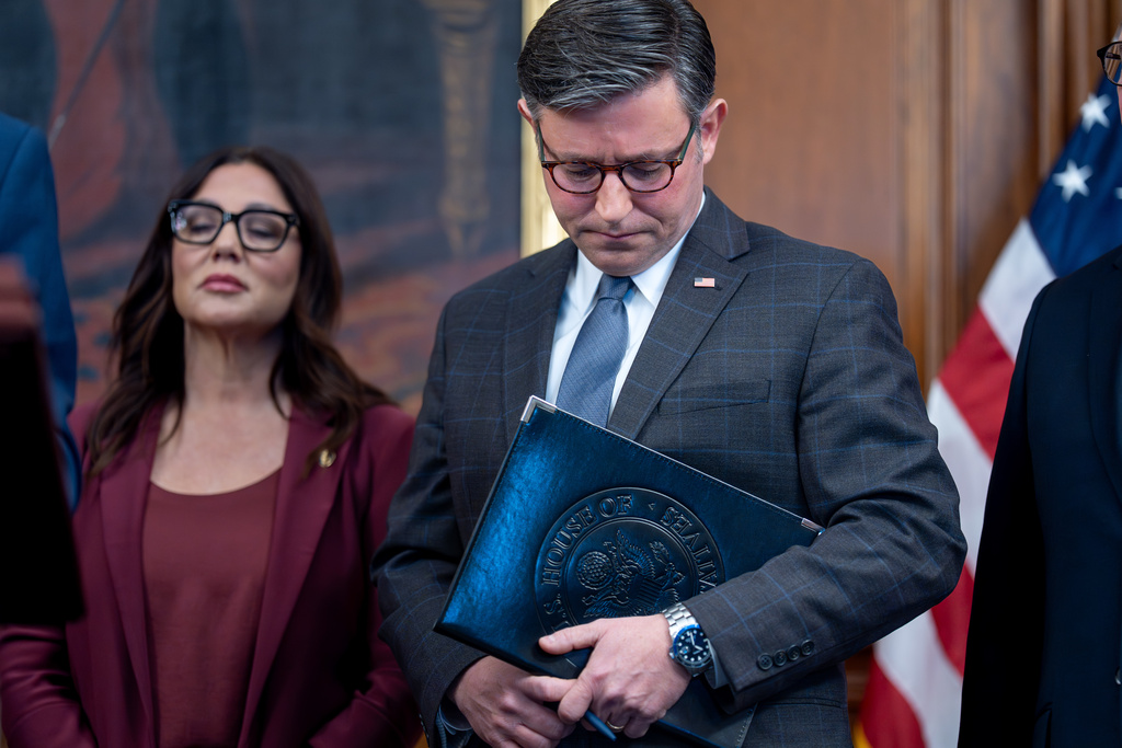 Speaker of the House Mike Johnson, R-La., center, joined by Secretary of Labor Lori Chavez-DeRemer, left, pauses while meeting with reporters on day 35 of the government shutdown, at the Capitol in Washington, Tuesday, Nov. 4, 2025. (AP Photo/J. Scott Applewhite)
