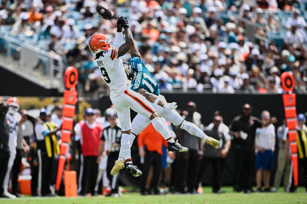 Cleveland Browns safety Grant Delpit (9) breaks up a pass intended for Jacksonville Jaguars wide receiver Parker Washington (11) in the first half of an NFL football game, Sunday, Sept. 13, 2026, in Jacksonville. (AP Photo/Phelan M. Ebenhack)