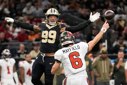 New Orleans Saints defensive end Chase Young (99) attempts to block a pass by Tampa Bay Buccaneers quarterback Baker Mayfield (6) during the second half of an NFL football game Sunday, Oct. 26, 2025, in New Orleans. (AP Photo/Gerald Herbert) New Orleans Saints defensive end Chase Young (99) attempts to block a pass by Tampa Bay Buccaneers quarterback Baker Mayfield (6) during the second half of an NFL football game Sunday, Oct. 26, 2025, in New Orleans. (AP Photo/Gerald Herbert)