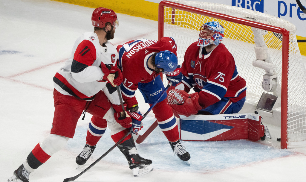 Montreal Canadiens goaltender Jakub Dobes (75) reacts as he is scored on by Carolina Hurricanes' Jordan Staal (11) as Canadiens' Josh Anderson (17) defends during the first period of Game 4 of NHL Eastern Conference final Stanley Cup playoff series action in Montreal, Quebec, Wednesday, May 27, 2026. (Christinne Muschi/The Canadian Press via AP)