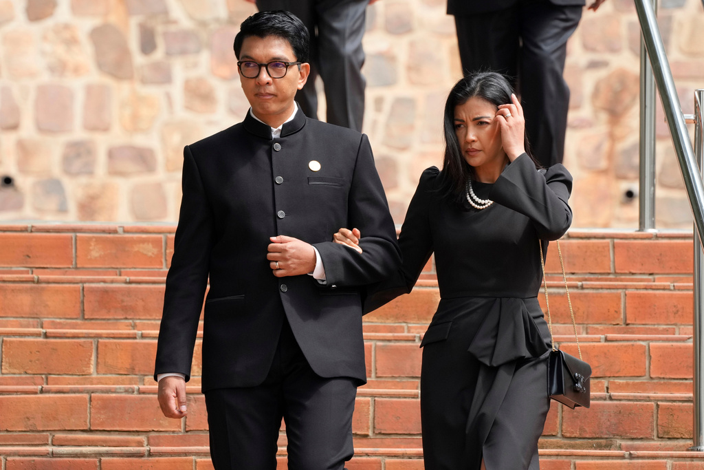 FILE - President of Madagascar Andry Rajoelina, left, and his wife Mialy Rajoelina arrive for a ceremony to mark the 30th anniversary of the Rwandan genocide, held at the Kigali Genocide Memorial, in Kigali, Rwanda, Sunday, April 7, 2024. (AP Photo/Brian Inganga, File)