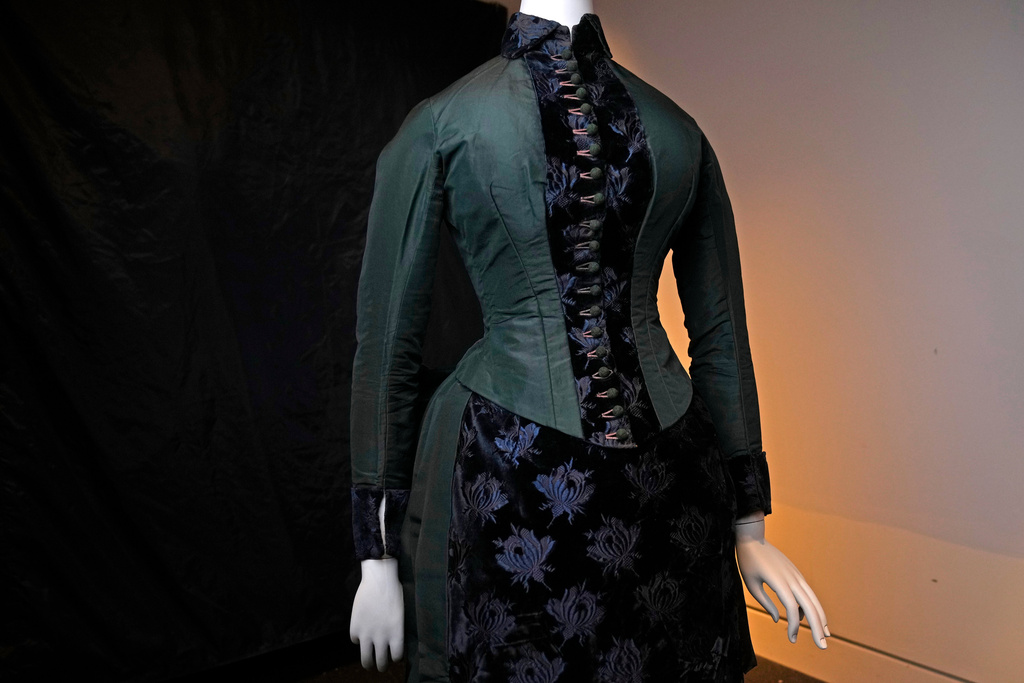 A vintage walking dress is held in preparation for The Metropolitan Museum of Art's spring exhibition, "Costume Art," on Thursday, Feb. 12, 2026, in New York. (Photo by Charles Sykes/Invision/AP)