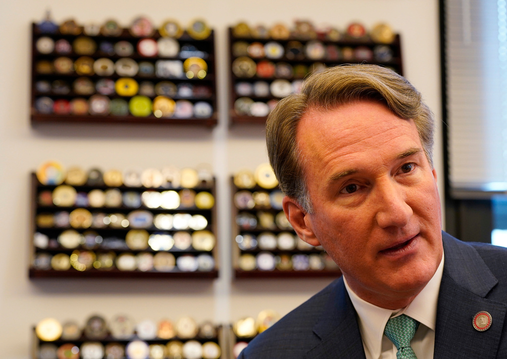 Virginia Gov. Glenn Youngkin gestures during an interview in his office at the Capitol Wednesday Dec. 10, 2025, in Richmond, Va. (AP Photo/Steve Helber)