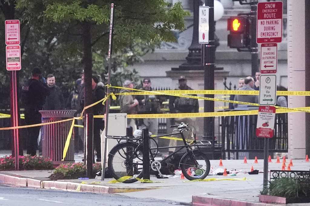 Evidence markers are seen on a crime scene after police responded to reports of shots fired near the White House, Saturday, May 23, 2026, in Washington. (AP Photo/Alex Brandon)