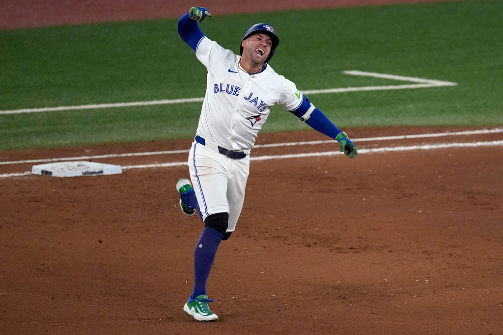 Toronto Blue Jays' George Springer celebrates his three run home run against the Seattle Mariners during the seventh inning in Game 7 of baseball's American League Championship Series, Monday, Oct. 20, 2025, in Toronto. (AP Photo/David J. Phillip)