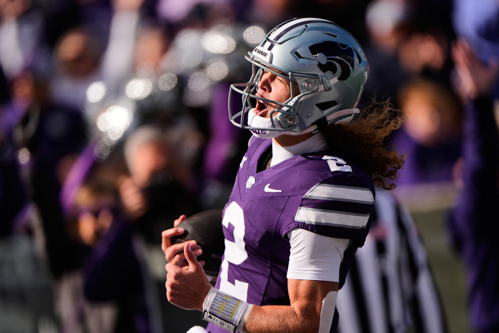 Kansas State quarterback Avery Johnson celebrates after scoring a touchdown during the first half of an NCAA college football game against Texas Tech, Saturday, Nov. 1, 2025, in Manhattan, Kan. (AP Photo/Charlie Riedel)