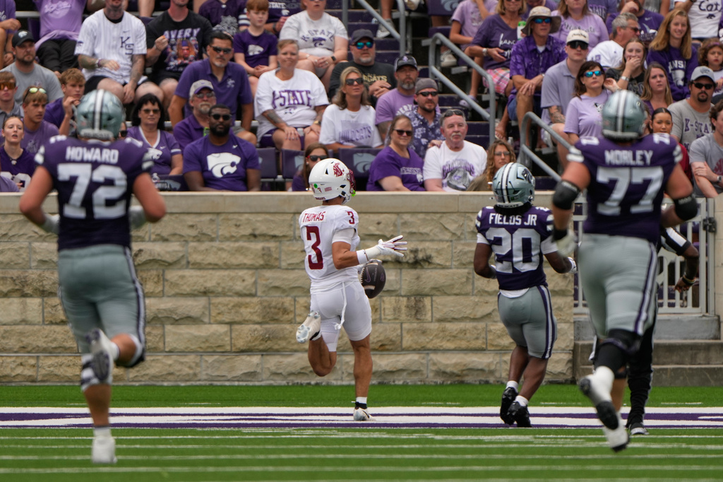 Washington State defensive back Jaylen Thomas (3) runs to score a touchdown after intercepting a pass during the first half of an NCAA college football game against Kansas State, Saturday, Sept. 12, 2026, in Manhattan, Kan. (AP Photo/Charlie Riedel)