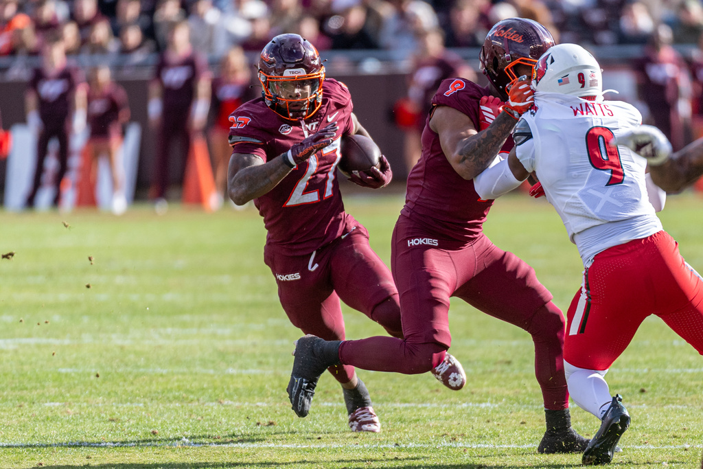 Virginia Tech running back Marcellous Hawkins (27) runs the ball against Louisville during the first half of an NCAA college football game, Saturday, Nov. 1, 2025, in Blacksburg, Va. (AP Photo/Robert Simmons)