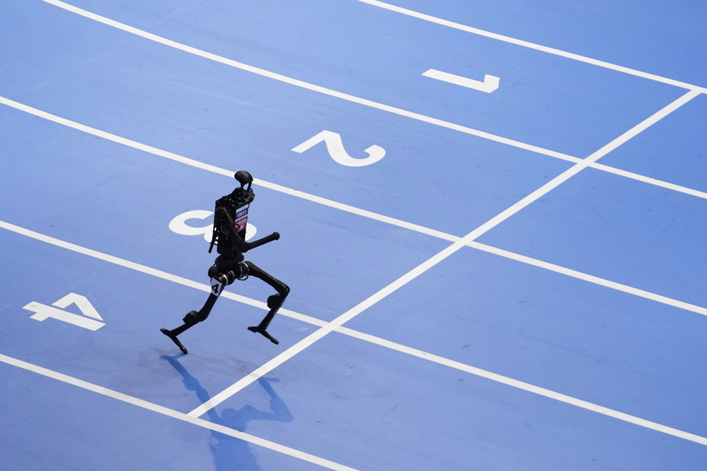 A robot competes in the 1500m race during the World Humanoid Robot Games in Beijing, China, Friday, Aug. 15, 2025. (AP Photo/Mahesh Kumar A.)