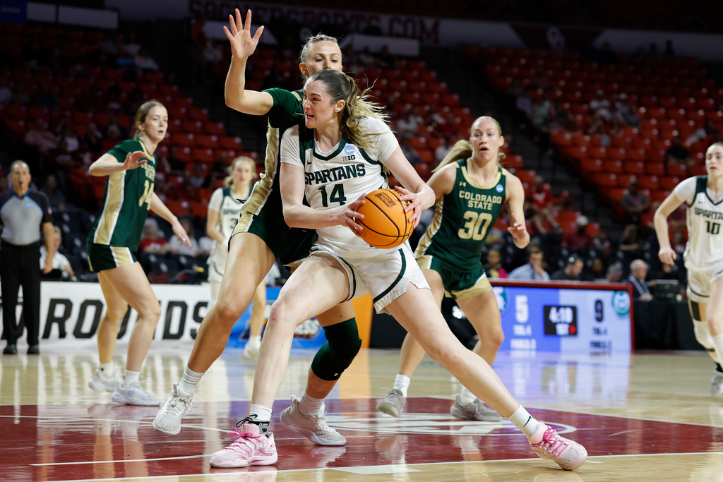 Michigan State forward Grace Vanslooten (14) drives to the basket past Colorado State forward Lexi Deden (6) during the first half in the first round of the NCAA college basketball tournament Friday, March 20, 2026, Norman, Okla. (AP Photo/Alonzo Adams)