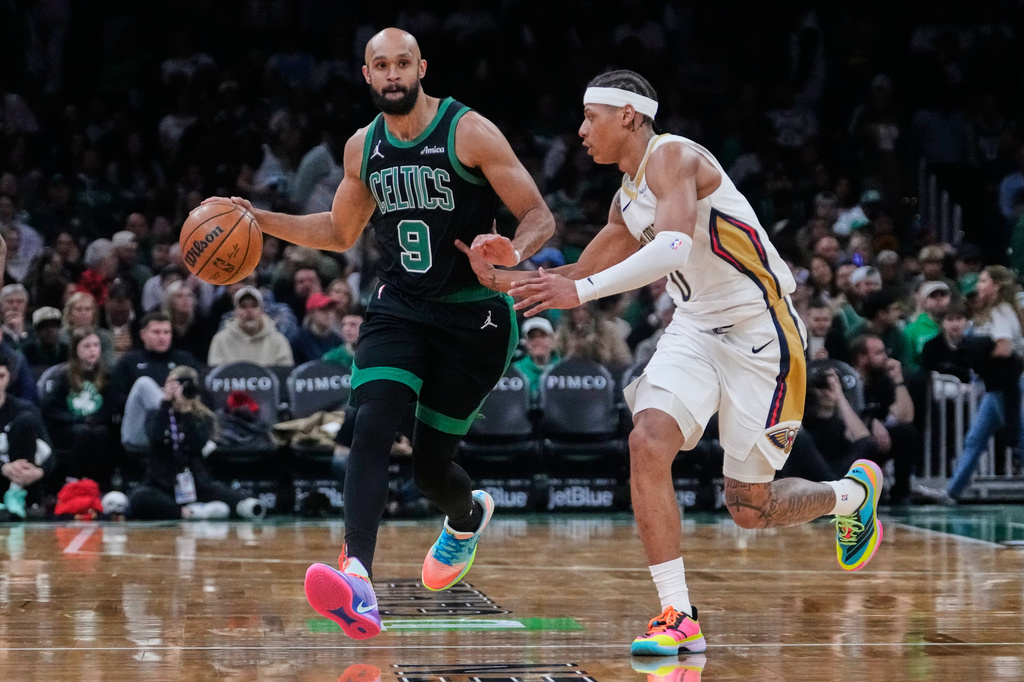 Boston Celtics guard Derrick White (9) drives to the basket against New Orleans Pelicans guard Jeremiah Fears, right, during the second half of an NBA basketball game, Friday, April 10, 2026, in Boston. (AP Photo/Charles Krupa)