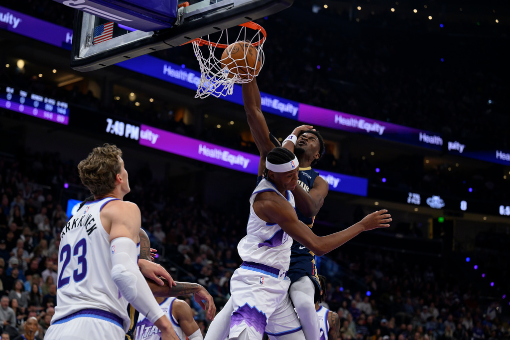 New Orleans Pelicans center Yves Missi, back right,=, dunks over Utah Jazz guard Ace Bailey, front right, during an NBA basketball game, Friday, Oct. 23, 2026, in Salt Lake City. (AP Photo/Tyler Tate)
