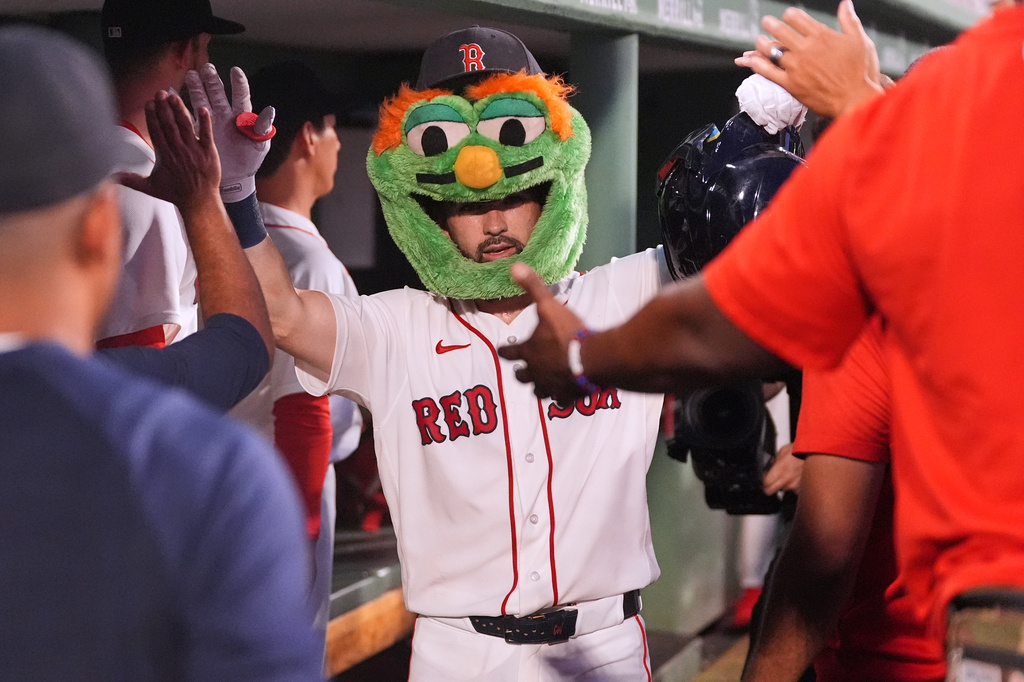 Boston Red Sox's Connor Wong is congratulated after his two-run home run during the third inning of a baseball game against the Chicago White Sox, Thursday, Aug. 6, 2026, in Boston. (AP Photo/Charles Krupa)