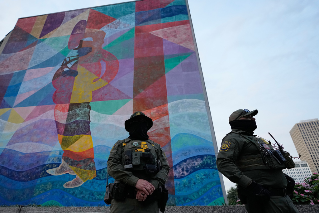 U.S. Border Patrol agents stand on the street in New Orleans, La.,Wednesday, Dec. 3, 2025. (AP Photo/Gerald Herbert)