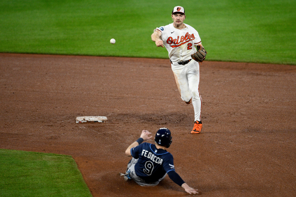 Tampa Bay Rays' Hunter Feduccia (9) is out at second as Baltimore Orioles shortstop Gunnar Henderson (2) throws to first base to put out Rays' Chandler Simpson for a double-play during the fifth inning of a baseball game, Wednesday, May 27, 2026, in Baltimore. (AP Photo/Nick Wass)