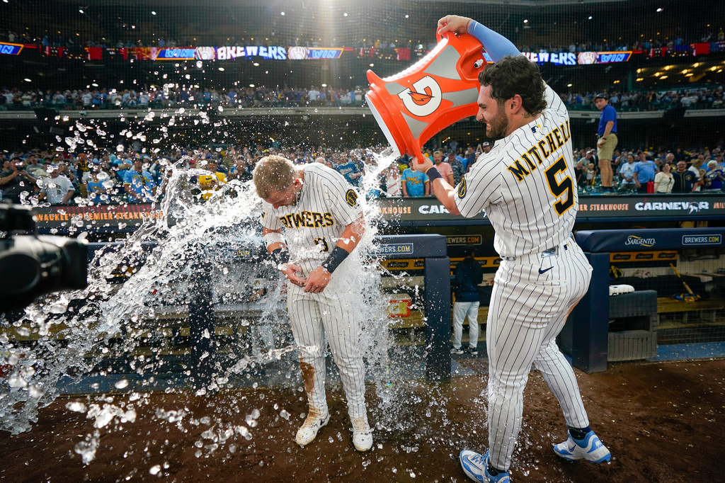 Milwaukee Brewers' Garrett Mitchell (5) douses Jake Bauers (9) after a baseball game against the Minnesota Twins, Sunday, Aug. 9, 2026, in Milwaukee. (AP Photo/Kayla Wolf)