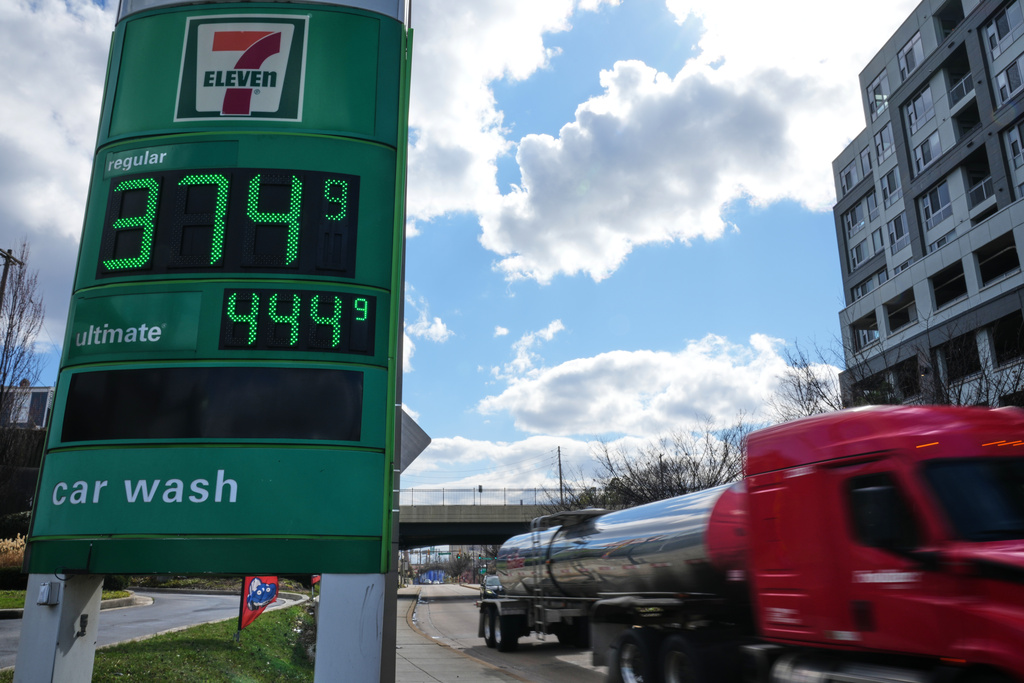 FILE - Fuel prices are displayed on a sign at a gas station as a fuel truck drives by, March 17, 2026, in Baltimore. (AP Photo/Stephanie Scarbrough, File)