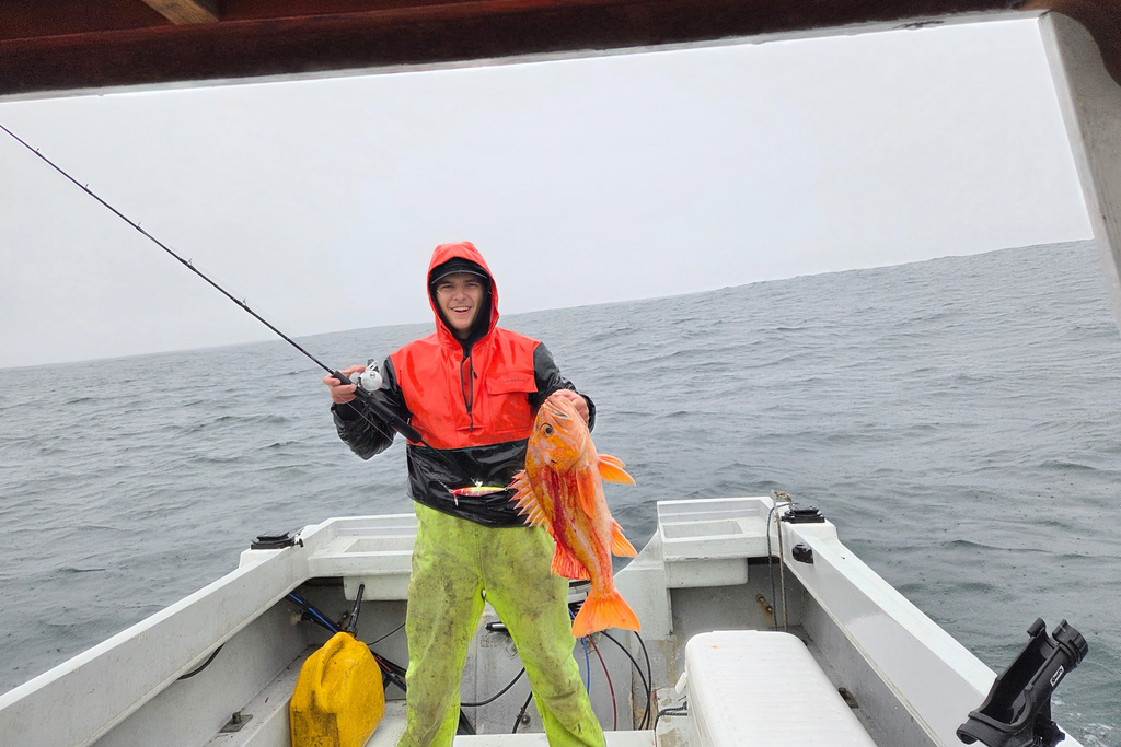 This photo, provided by Deirdre Lamb, shows Mendocino County fisherman Brendan Walsh, with a 10.25 lbs. canary rockfish he caught of the coast of Albion, about 150 miles north of San Francisco on Tuesday, Dec. 16, 2025. (Deidre Lamb via AP)
