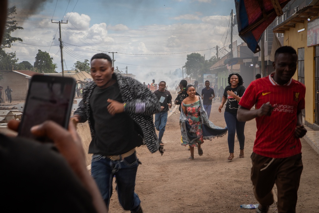 People run during a protest on the streets of Arusha, Tanzania, on election day Wednesday, Oct. 29, 2025. (AP Photo/str)