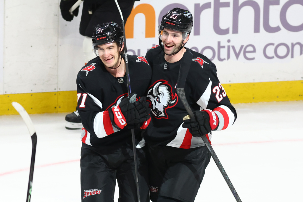Buffalo Sabres center Ryan McLeod, left, celebrates his empty net goal with defenseman Mattias Samuelsson (23) during the third period of an NHL hockey game against the Philadelphia Flyers, Thursday, Dec. 18, 2025, in Buffalo, N.Y. (AP Photo/Jeffrey T. Barnes)