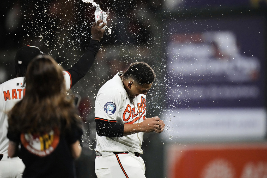 Baltimore Orioles' Samuel Basallo is doused by Baltimore Jorge Mateo after hitting a walk-off single during the 11th inning of a baseball game against the Pittsburgh Pirates, Tuesday, Sept. 9, 2025, in Baltimore. (AP Photo/Stephanie Scarbrough)
