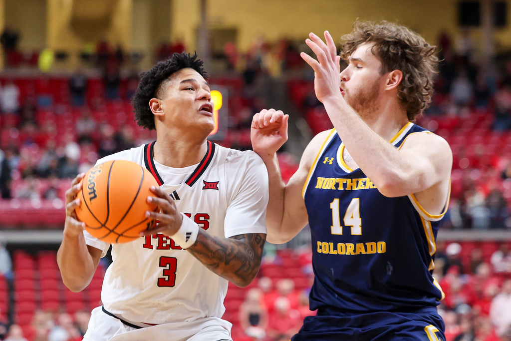 Texas Tech forward Lejuan Watts (3) drives against Northern Colorado forward Brock Wisne (14) during the first half of an NCAA college basketball game, Tuesday, Dec. 16, 2025, in Lubbock, Texas. (AP Photo/Chase Seabolt)