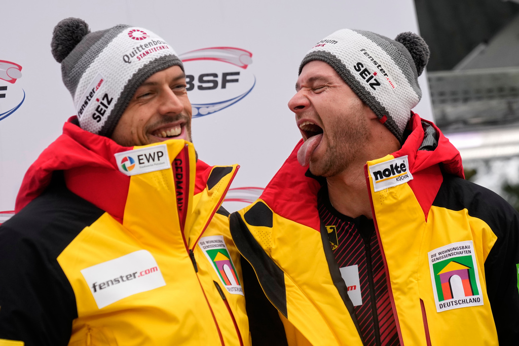 Johannes Lochner and Georg Fleischhauer of Germany celebrate winning the 2-man bobsleigh, at the Bobsleigh World Cup in Innsbruck, Austria, Saturday, Nov. 29, 2025. (AP Photo/Matthias Schrader)