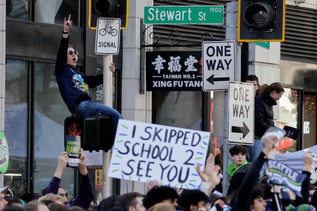 Seattle Seahawks fans cheer during the team's NFL football Super Bowl 60 parade and celebration, Wednesday, Feb. 11, 2026, in Seattle. (AP Photo/John Froschauer)