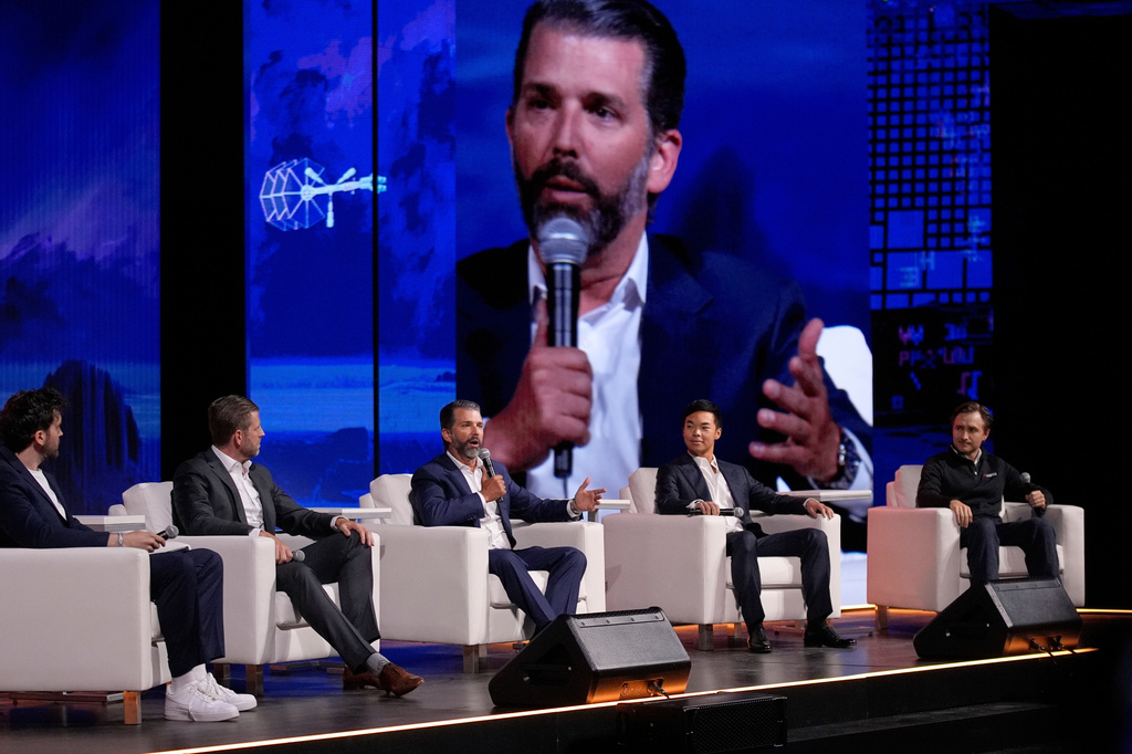 FILE - From left, moderator Aaron Arnold, Eric Trump, Donald Trump Jr., Mike Ho, executive chairman of American Bitcoin and Matt Prusak, CEO of American Bitcoin, sit on stage at Bitcoin 2025, Wednesday, May 28, 2025, in Las Vegas. (AP Photo/John Locher, File)