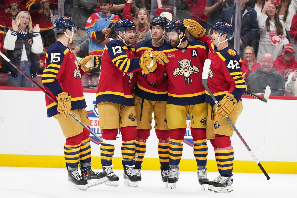 Florida Panthers defenseman Aaron Ekblad, second from right, is congratulated after scoring a goal during the second period of an NHL hockey game against the Colorado Avalanche, Sunday, Jan. 4, 2026, in Sunrise, Fla. (AP Photo/Lynne Sladky)
