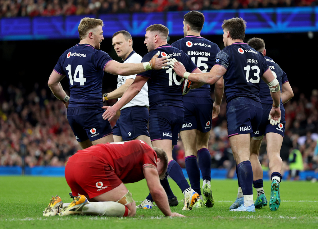 Scotland's Finn Russell, second left, celebrates scoring a try during the Six Nations rugby union match between Wales and Scotland in Cardiff, Wales, Saturday Feb. 21, 2026. (Nigel French/PA via AP)