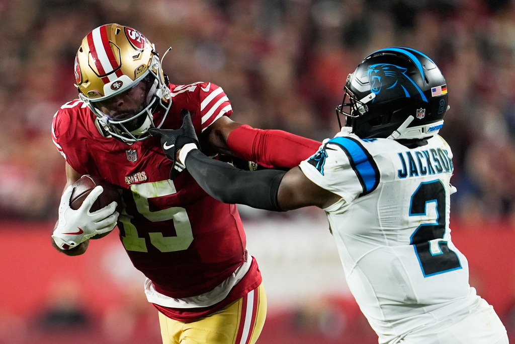 San Francisco 49ers wide receiver Jauan Jennings pushes off Carolina Panthers cornerback Mike Jackson during the second half an NFL football game, Monday, Nov. 24, 2025, in Santa Clara, Calif. (AP Photo/Godofredo A. Vásquez)