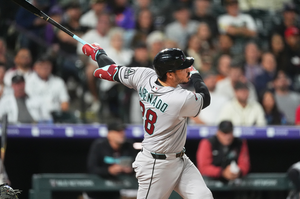 Arizona Diamondbacks' Nolan Arenado watches his solo home run off Colorado Rockies relief pitcher Zach Agnos in the seventh inning of a baseball game Tuesday, Sept. 22, 2026, in Denver. (AP Photo/David Zalubowski)