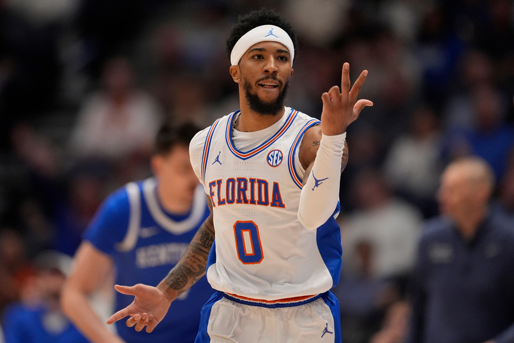 Florida guard Boogie Fland (0) celebrates his three-point shot against Kentucky during the first half of an NCAA college basketball game in the quarterfinal round of the Southeastern Conference tournament, Friday, March 13, 2026, in Nashville, Tenn. (AP Photo/George Walker IV)