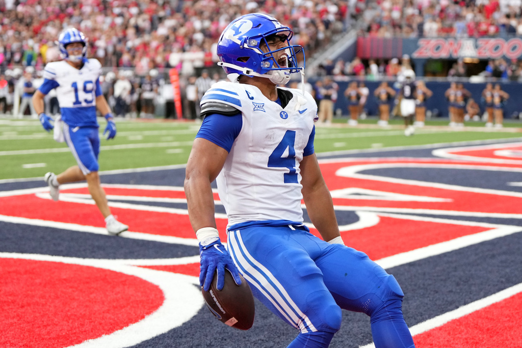 BYU running back LJ Martin (4) reacts after scoring a touchdown against Arizona in the first half of an NCAA college football game Saturday, Oct. 11, 2025, in Tucson, Ariz. (AP Photo/Rick Scuteri)