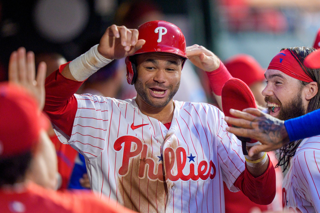 Philadelphia Phillies' Justin Crawford, center, celebrates with teammates after scoring during the third inning of a baseball game against the Miami Marlins, Monday, Aug. 17, 2026, in Philadelphia. (AP Photo/Chris Szagola)