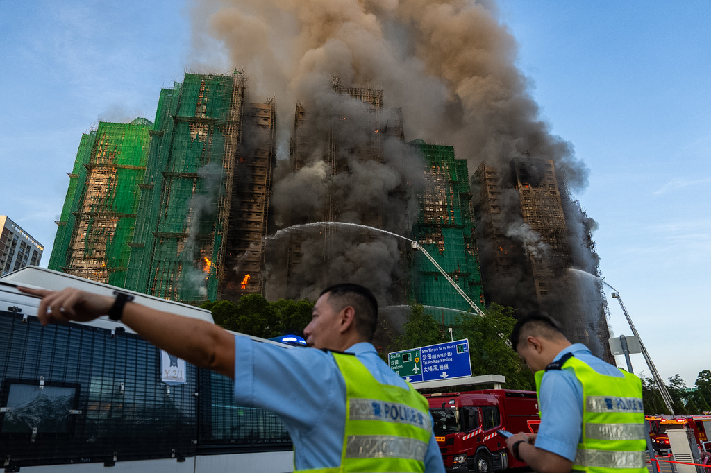 First responders work the scene of a fire at Wang Fuk Court, a residential estate in the Tai Po district of Hong Kong's New Territories on Wednesday, Nov. 26 2025. (AP Photo/Chan Long Hei)