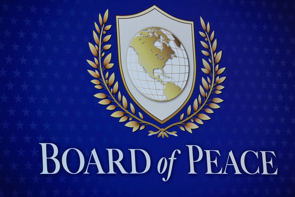 A logo is shown prior to the Board of Peace charter announcement by President Donald Trump at the Annual Meeting of the World Economic Forum in Davos, Switzerland, Thursday, Jan. 22, 2026. (AP Photo/Evan Vucci)