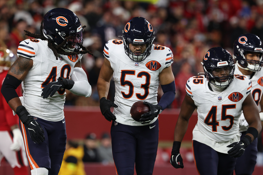 Chicago Bears linebacker T.J. Edwards (53) is congratulated by teammates after returning an interception for a touchdown during the first half of an NFL football game against the San Francisco 49ers in Santa Clara, Calif., Sunday, Dec. 28, 2025. (AP Photo/Jed Jacobsohn)