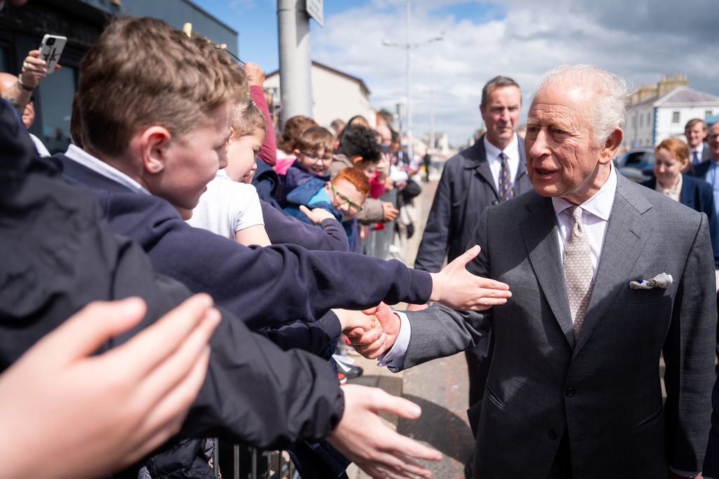 Britain's King Charles III, right, meets well-wishers outside The Pantry Foodbank in Donard Methodist Church, Newcastle, Northern Ireland, Wednesday, May 20, 2026. (Aaron Chown/PA via AP)