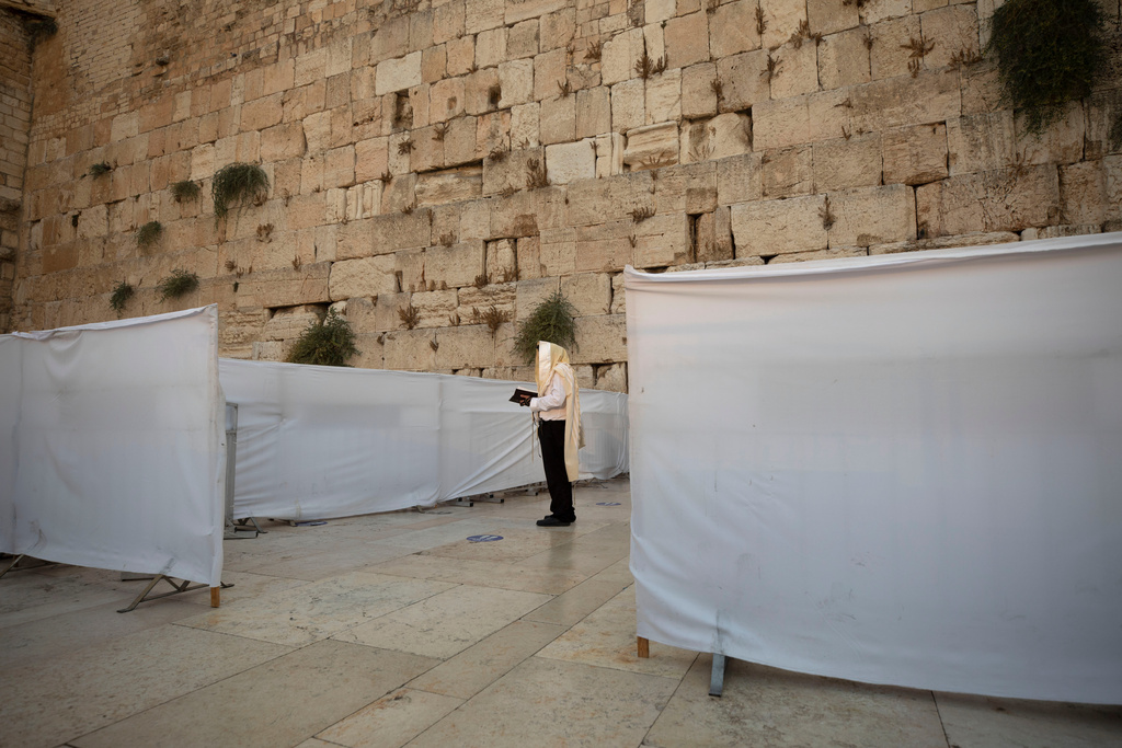 FILE - An ultra-Orthodox Jewish man prays ahead of the Jewish new year at the Western Wall, the holiest site where Jews can pray in Jerusalem's old city, Wednesday, Sept. 16, 2020. (AP Photo/Sebastian Scheiner, File)