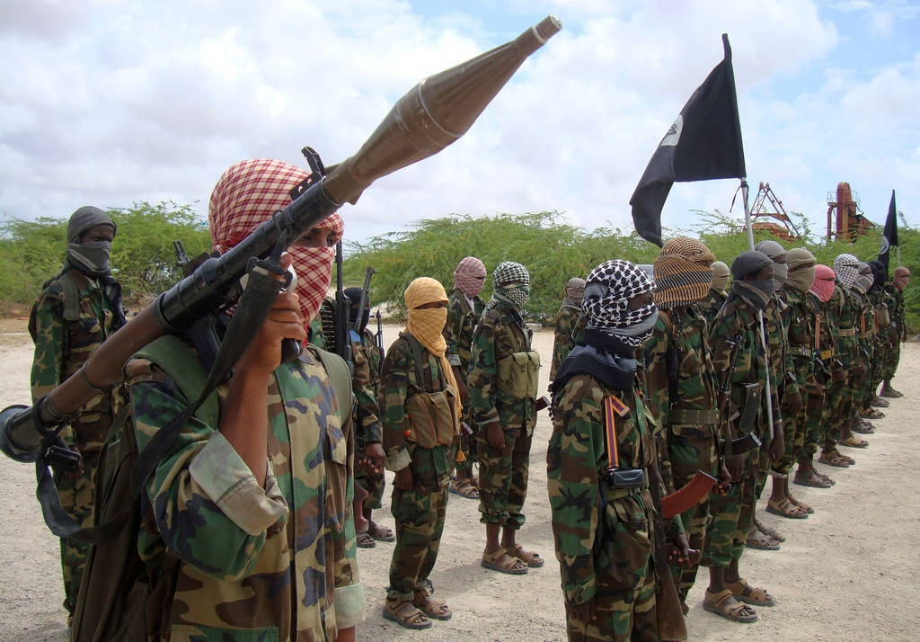 FILE - Al-Shabab fighters display weapons as they conduct military exercises in northern Mogadishu, Somalia, Oct. 21, 2010. (AP Photo/Farah Abdi Warsameh, File)