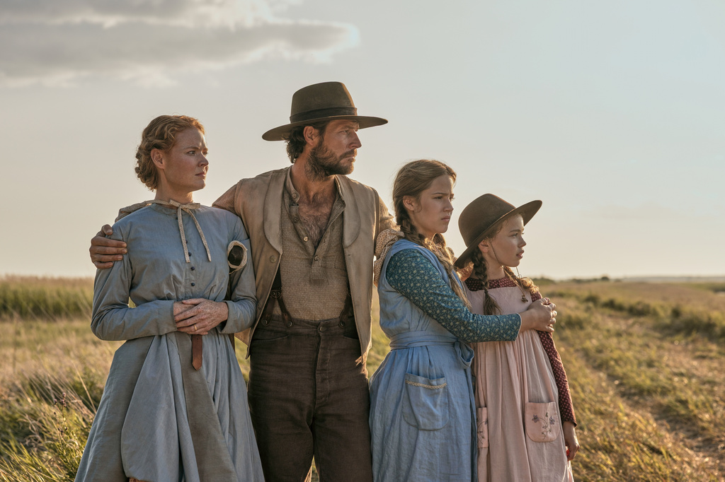 This image released by Netflix shows, from left, Crosby Fitzgerald as Caroline Ingalls, Luke Bracey as Charles Ingalls, Skywalker Hughes as Mary Ingalls, and Alice Halsey as Laura Ingalls in a scene from "Little House on the Prairie." (Eric Zachanowich/Netflix via AP)