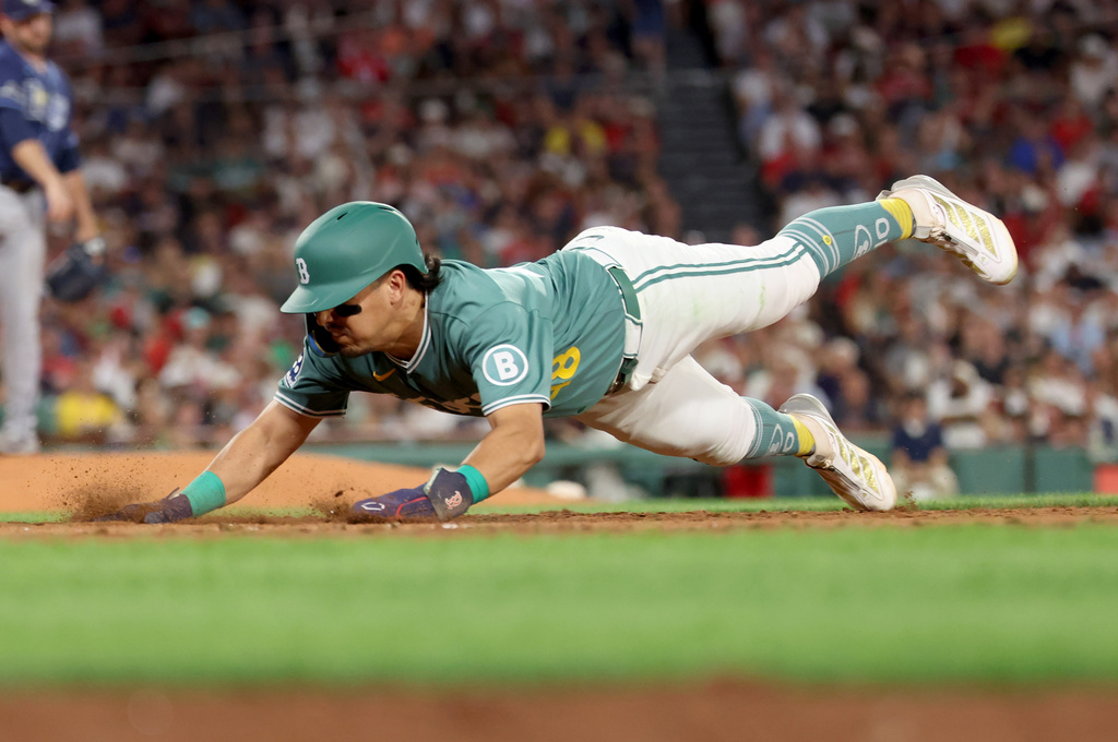 Boston Red Sox's Anthony Seigler dives safely back to first base during the seventh inning of the second baseball game of a doubleheader against the Tampa Bay Rays, Friday, July 17, 2026, in Boston. (AP Photo/Mark Stockwell)