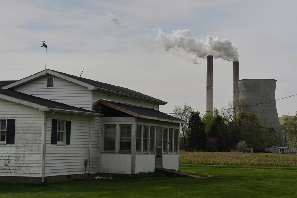 FILE - A home sits near the Gen. James Gavin Power Plant, a coal-fired power plant, April 14, 2025, in Cheshire, Ohio. (AP Photo/Joshua A. Bickel, File)