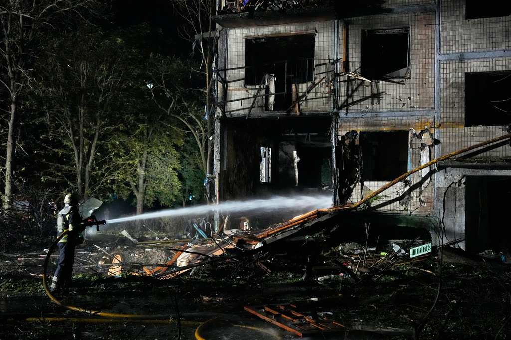 Emergency services personnel work to extinguish a fire following Russian missile attacks in Kyiv, Ukraine, Saturday, Aug. 1, 2026. (AP Photo/Efrem Lukatsky)