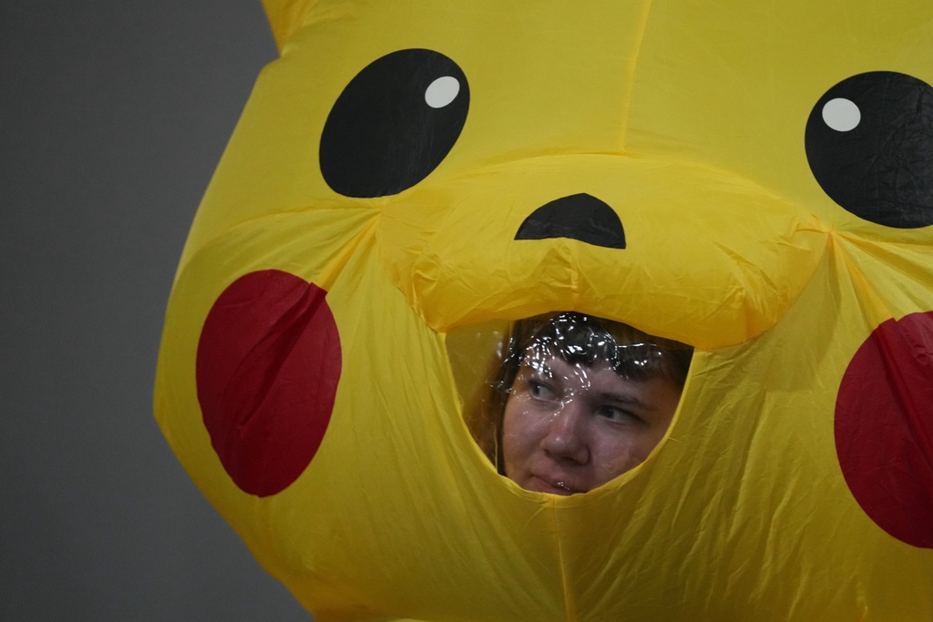 An activist, in a Pikachu costume, protests Japan's financing of coal and natural gas projects during the COP30 U.N. Climate Summit, Friday, Nov. 14, 2025, in Belem, Brazil. (AP Photo/Fernando Llano)