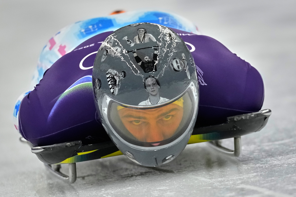 Ukraine's Vladyslav Heraskevych starts a men's skeleton training session at the 2026 Winter Olympics, in Cortina d'Ampezzo, Italy, Monday, Feb. 9, 2026. (AP Photo/Alessandra Tarantino)