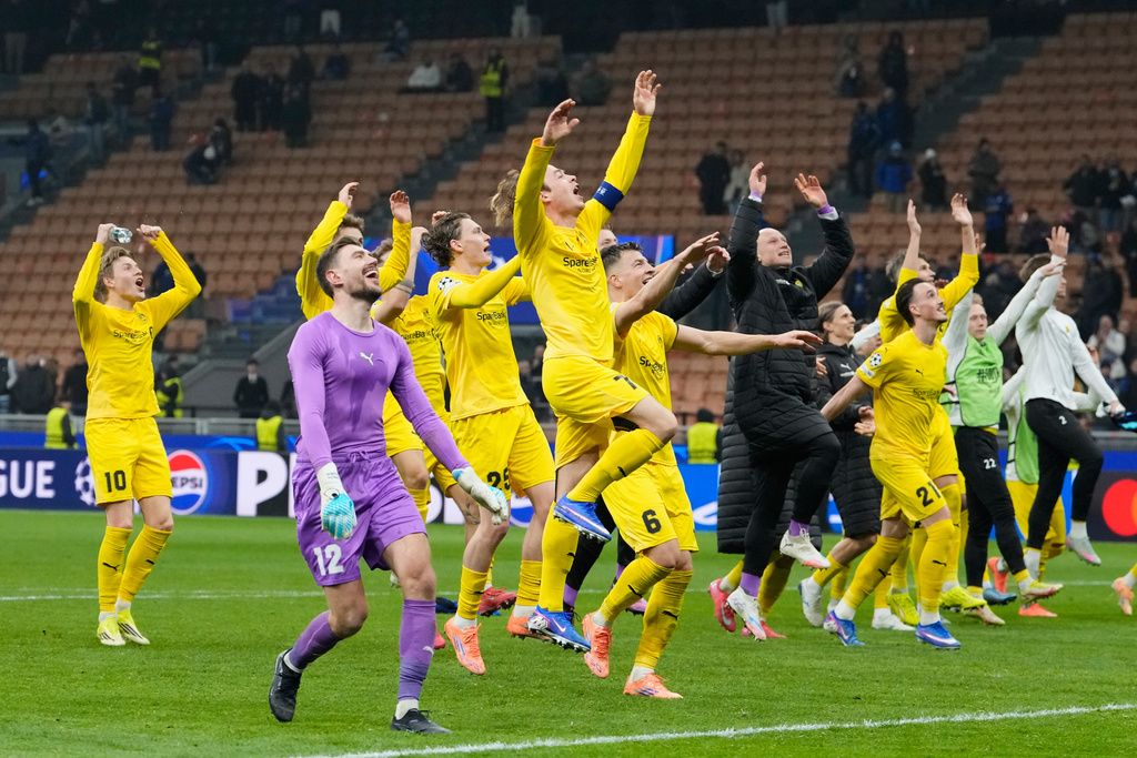 Glimt's players celebrate at the end of the Champions League playoff soccer match between Inter Milan and Bodo Glimt, at the San Siro stadium in Milan, Italy, Tuesday, Feb.24, 2026. (AP Photo/Luca Bruno)